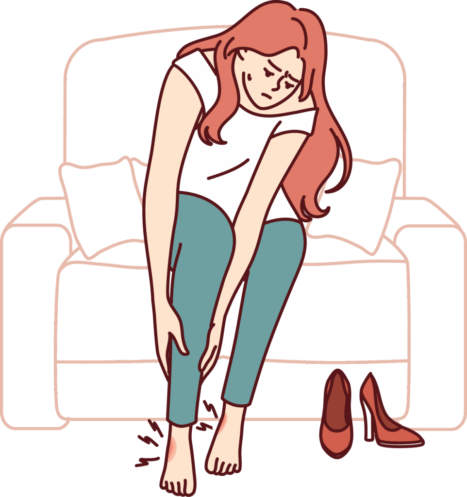 woman kneeling over to massage her hurting ankles and feet after removing shoes