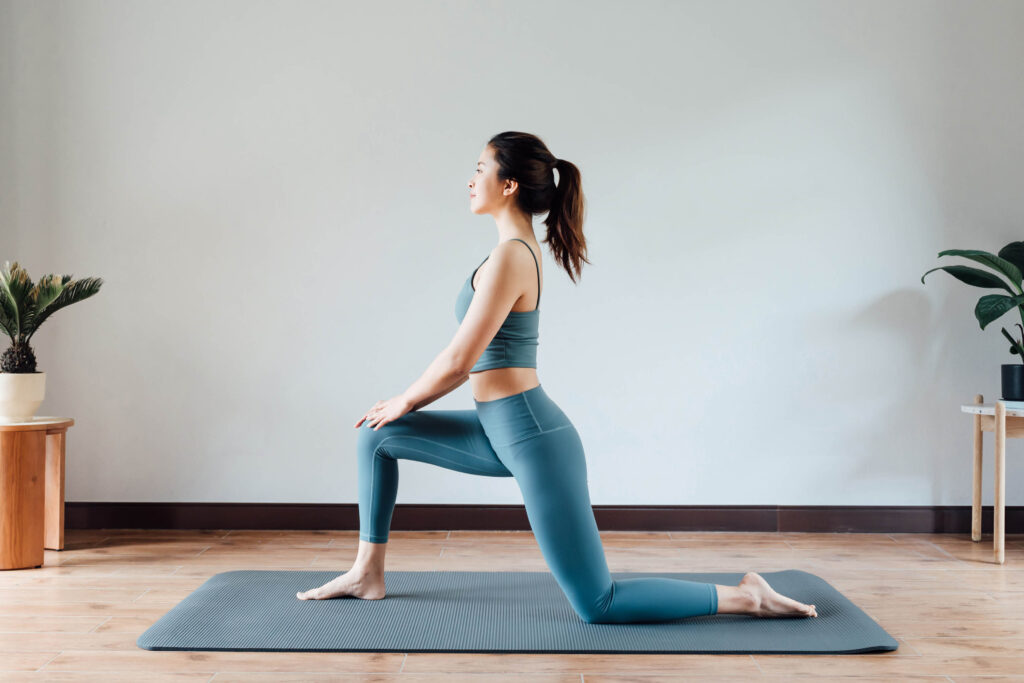 woman stretching in her home to prevent muscle pain