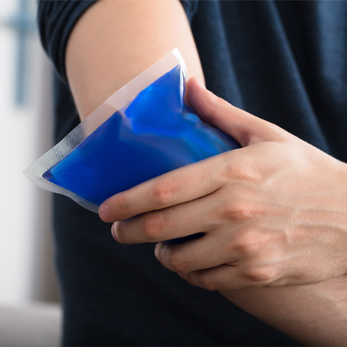Athlete holding an ice pack against their sore elbow