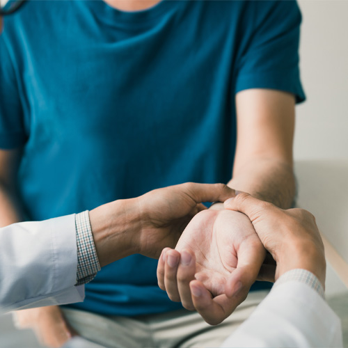 Physical therapist examining their patient’s wrist to determine a treatment plan