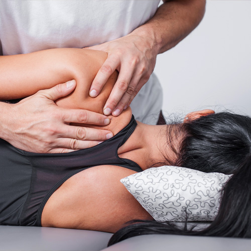 Physical therapist doing an exercise on the patient’s shoulder to help mobility