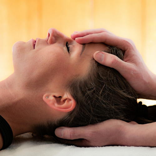 therapist holds patient head to prepare for vestibular therapy